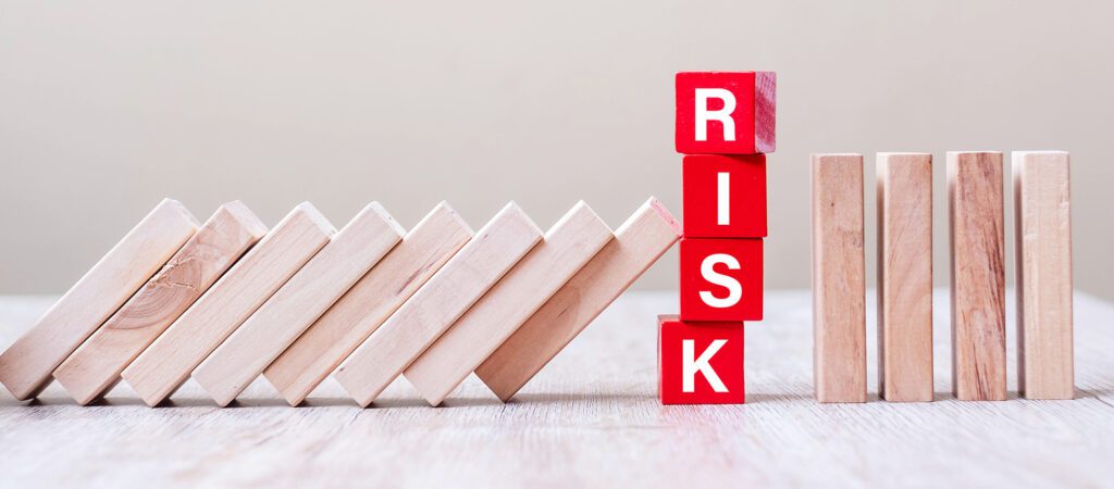 Red RISK cube blocks stop falling blocks on table. fall Business, planning, Management, Solution, Insurance and strategy Concepts